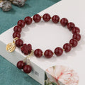 Women's purple gold sand fu character bracelet with peach blossom tassel detailing and handcrafted cinnabar construction