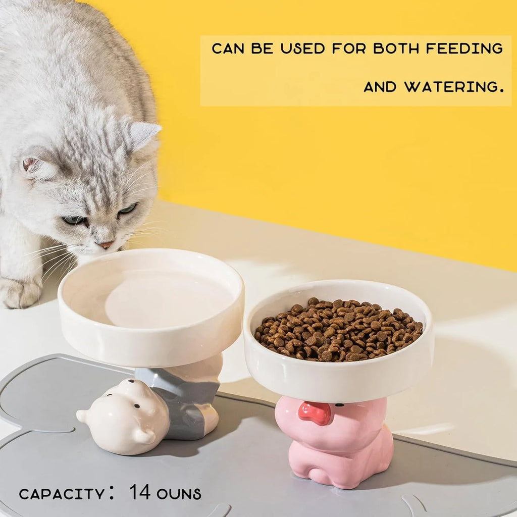 Raised ceramic cat food bowl in an animal theme design on a white background