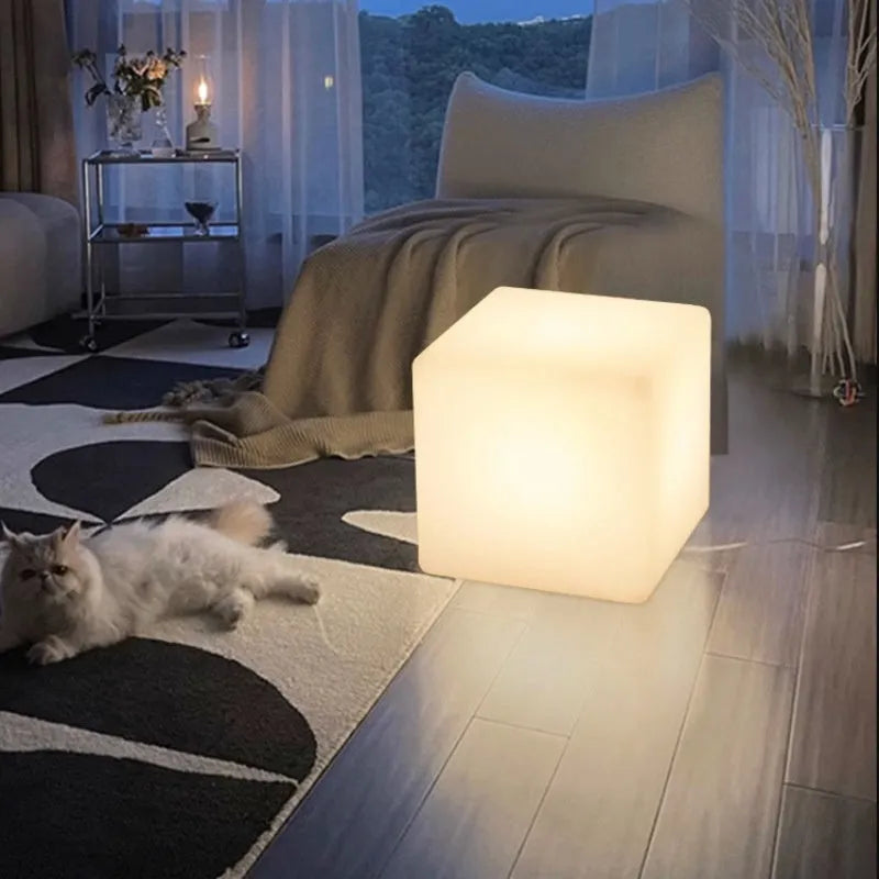 White square LED cube light stool on grass, showing modern design and waterproof build for outdoor use.