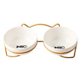 White ceramic cat bowl with decorative iron frame showing cat paw print pattern