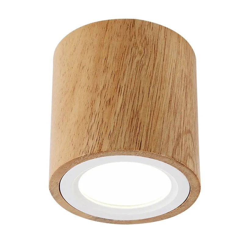 Modern solid wood surface mounted downlight in wood colour, shown in round and square shapes.