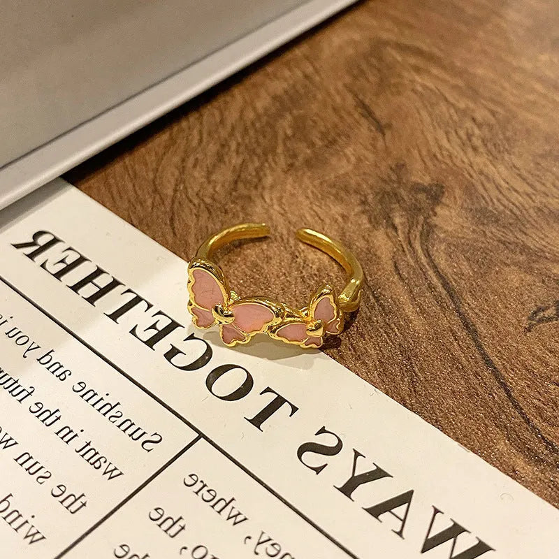 Simple copper women's ring with a Chinese butterfly design, showing an example from the 33 available numbered styles.