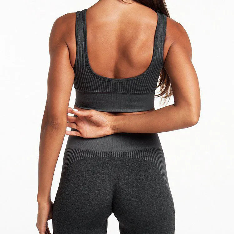 Women's seamless shorts fitness suit in charcoal with fitted top and shorts, three-quarter view on model