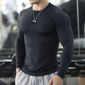 Man wearing black slim fit long sleeve fitness tights for running or gym workout.