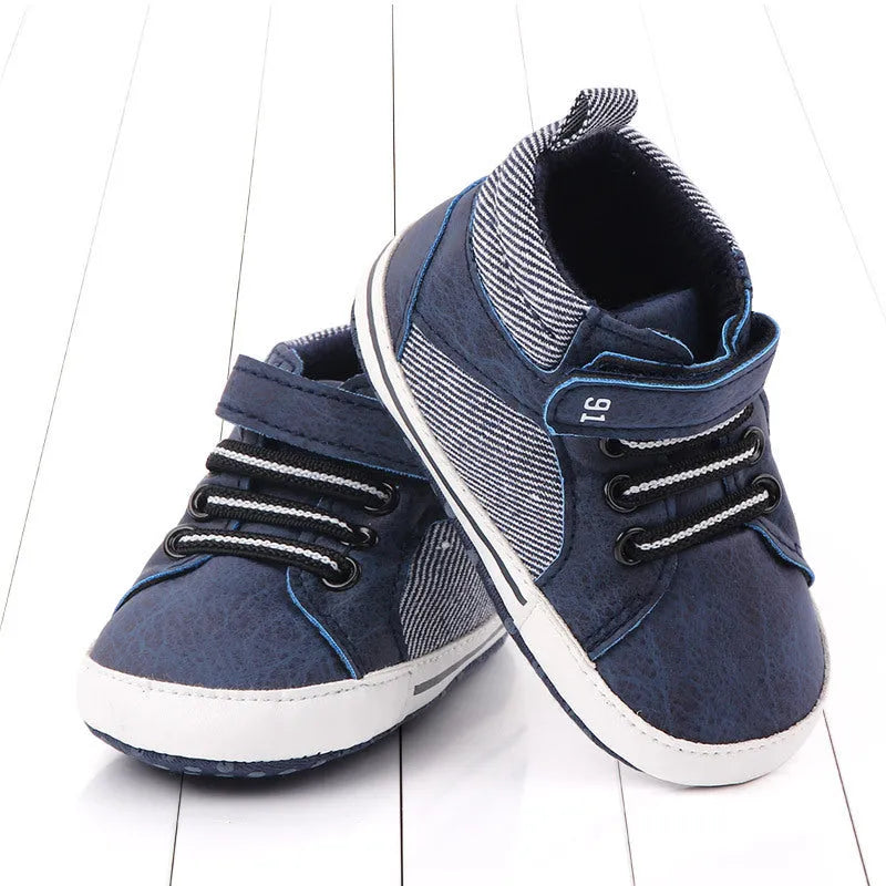 Blue cotton high-top toddler shoes with velcro strap for boys on white background