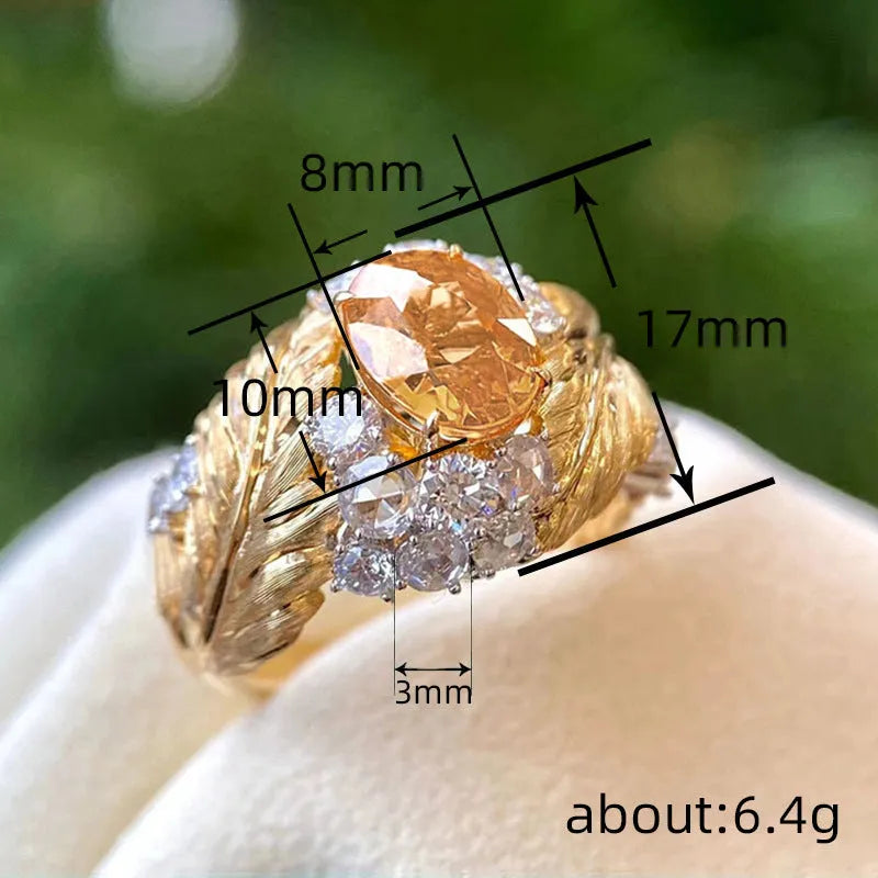 Women's gold embossed feather ring with geometric design and yellow zircon stones