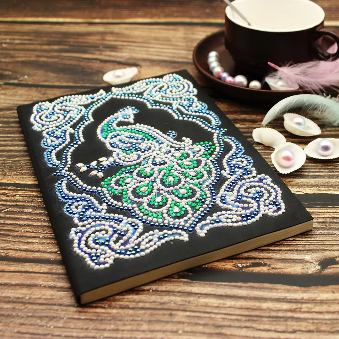 Peacock Beauty A5 diamond painting journal with black cover, shaped and bright drills, showing 142x207mm dimensions.