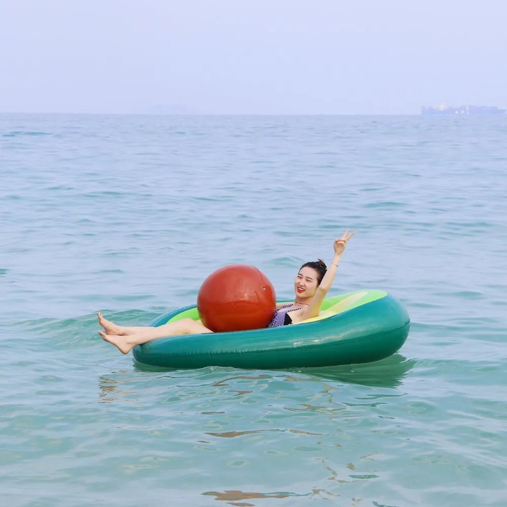 Giant green avocado-shaped inflatable pool float measuring 169cm by 130cm.