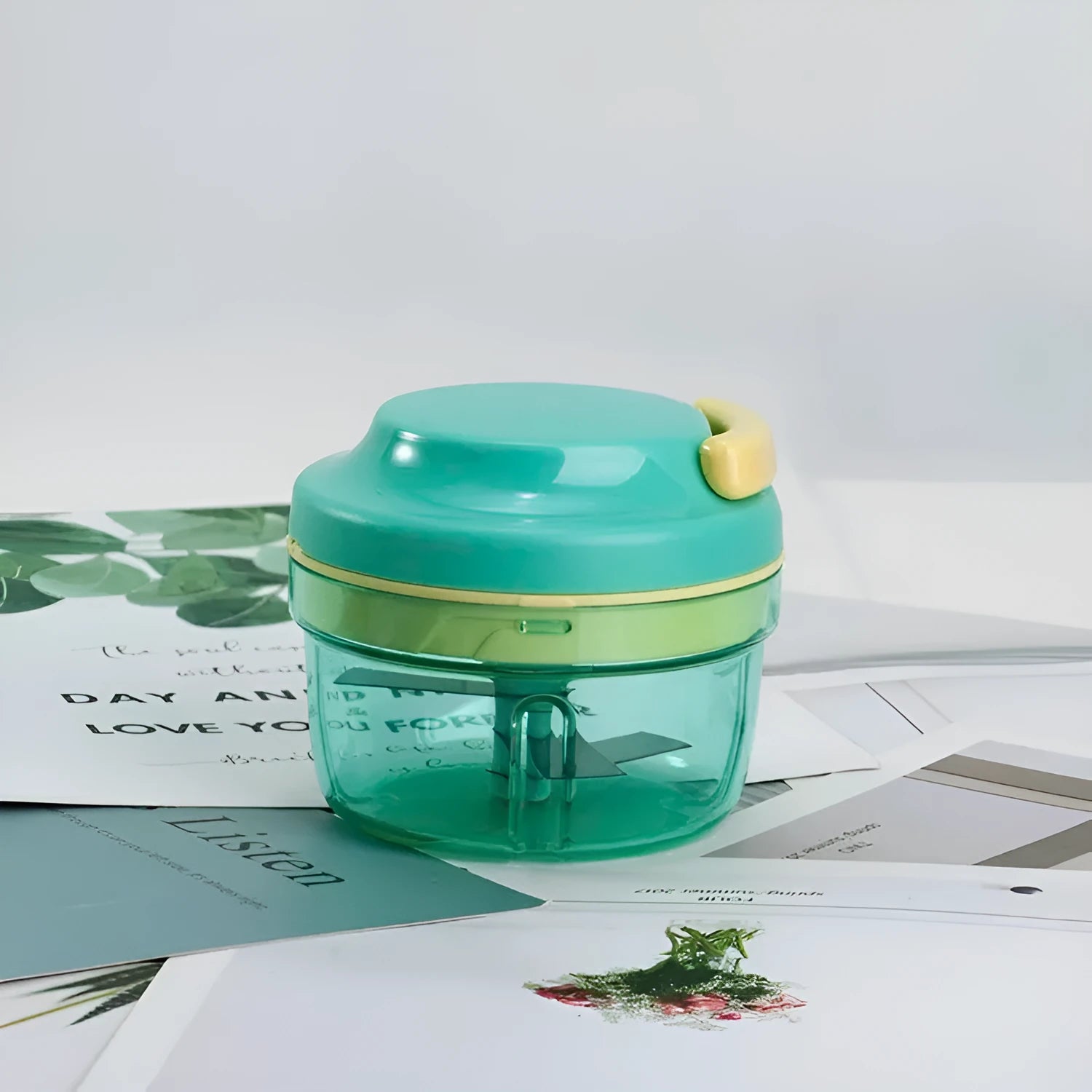 Green manual baby food maker and garlic grinder with 300ml container and stainless steel blade.
