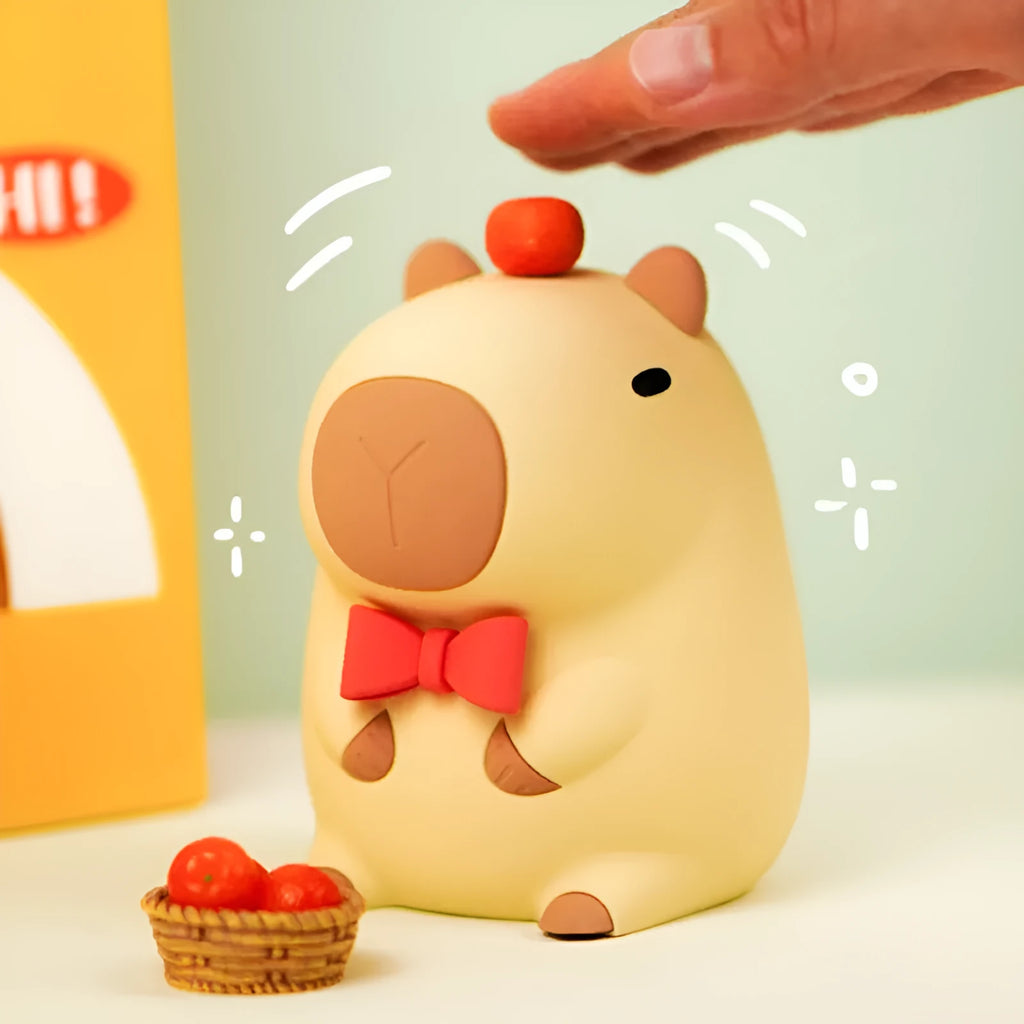 Cute brown Capybara silicone night lamp with soft glow on a bedside table.