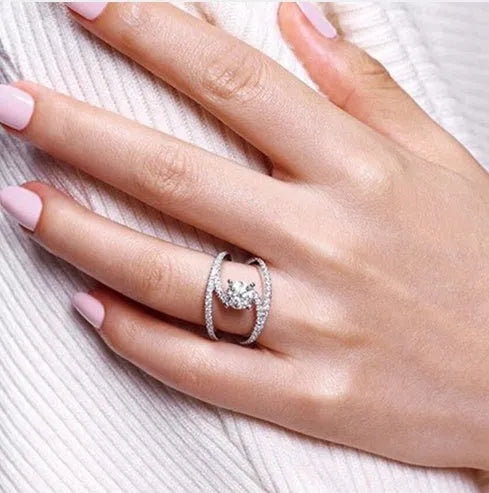 Silver copper ring with inlaid zircon and geometric curved design on white background