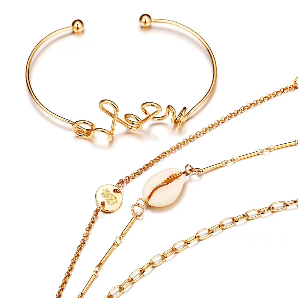 Set of four alloy bracelets in multicolour designs arranged in a gift box