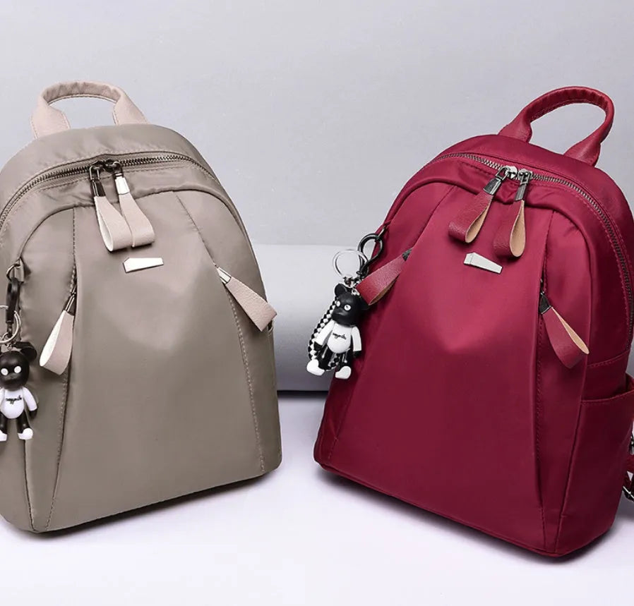 Medium wine red Oxford cloth rucksack showing internal phone and ID compartments