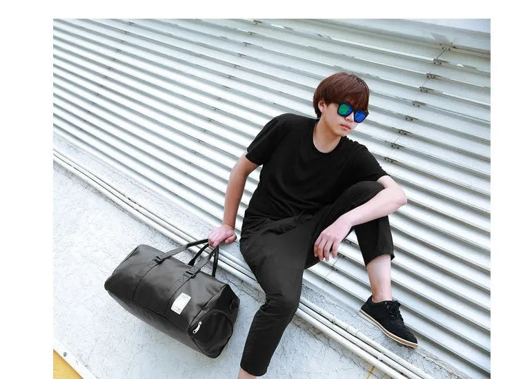 Black waterproof sports fitness bag with a separate shoe compartment and a diagonal carry strap.