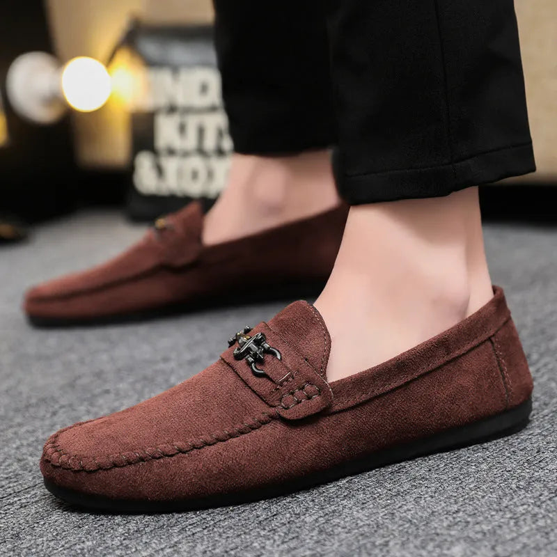 Men's black slip-on loafers with round toe and low stiletto heel, showing sewing thread detailing on artificial PU leather upper