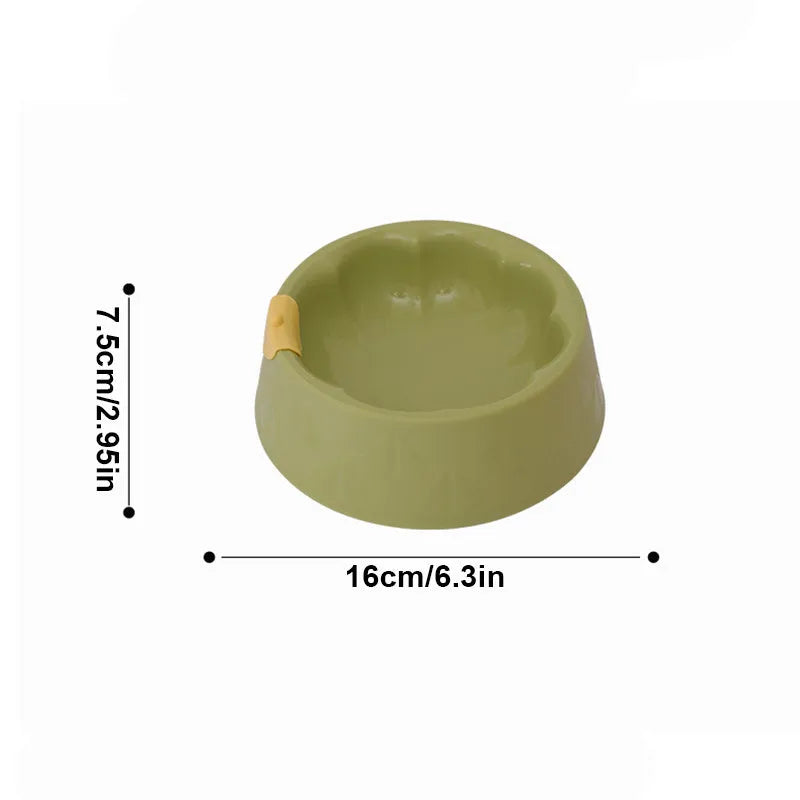 Green plastic double pet bowl with flower-shaped design and anti-tip base for cats and small dogs.
