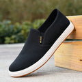 Men's low-top canvas slip-on shoes with rounded toe and injection moulded soles in black and blue colour options
