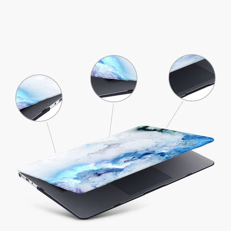 Custom painted hard plastic shell case for MacBook in black colour on a laptop