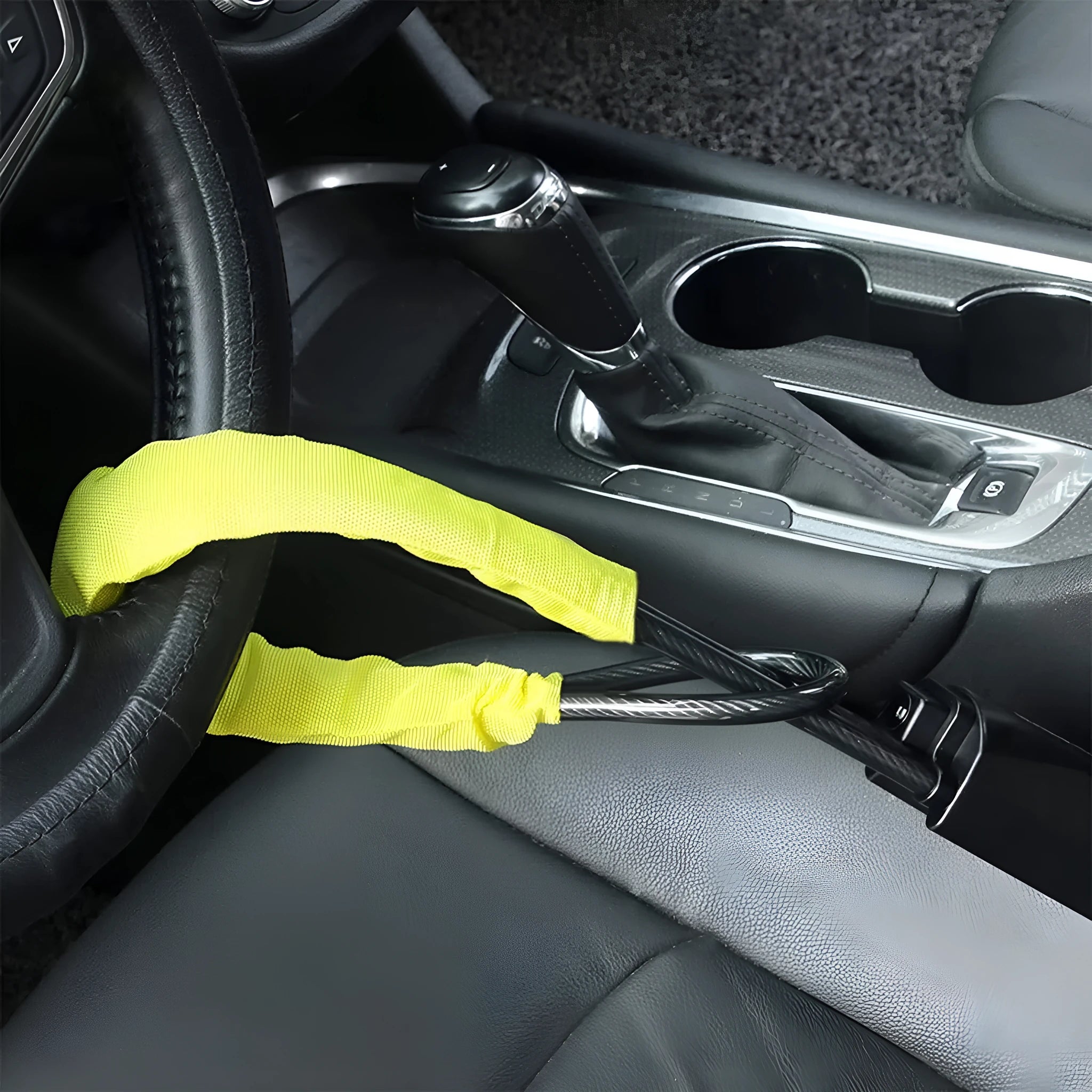 Red iron car steering wheel lock with copper core for General Motors vehicles on a steering wheel.