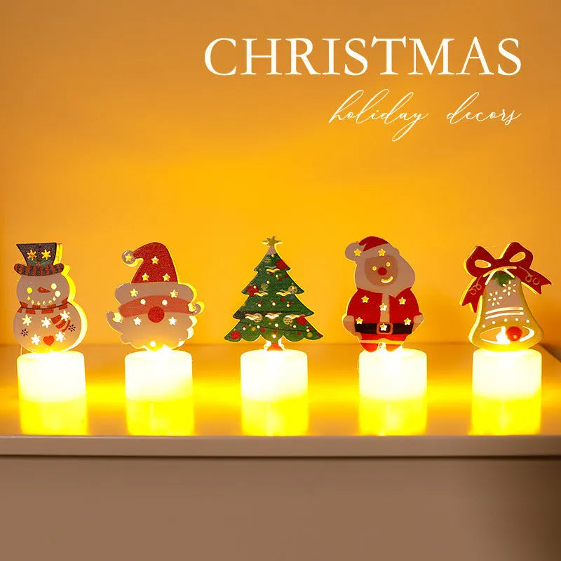 Assorted LED electronic candles featuring Christmas tree, Santa Claus, and snowman designs on a table