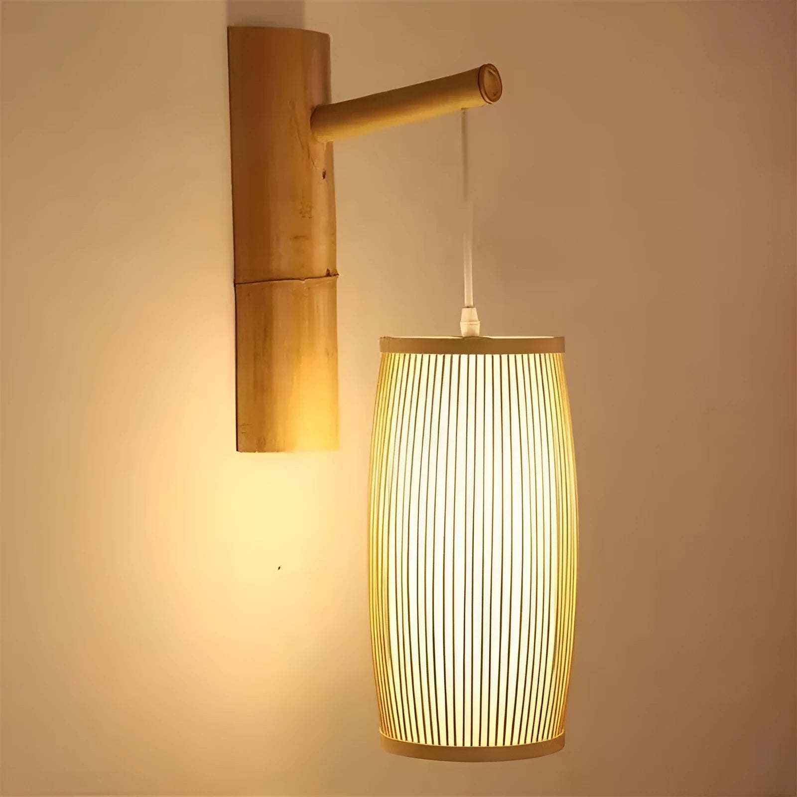 Small bamboo plaited wall light with natural finish, shown mounted on a wall.