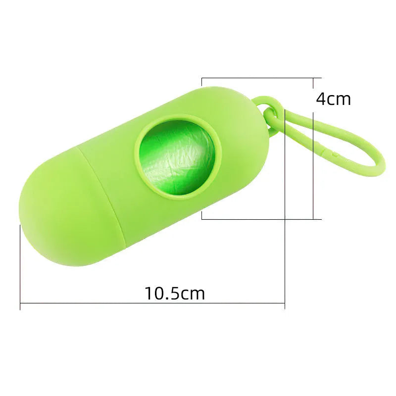 Compact black dog poop bag holder with a metal side hook and a grey Velcro adjustment strap.
