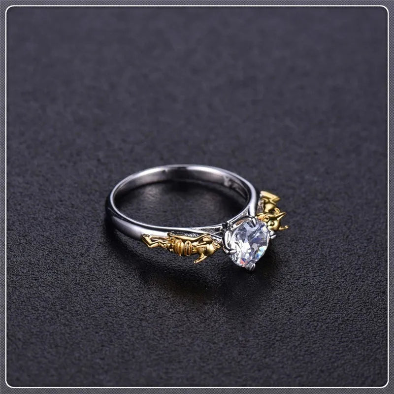 Black gold finished copper ring with a detailed crown motif and crystal settings on a finger.