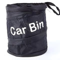 Foldable black polyester car bin bag with hanging strap and magic sticker on a car seat