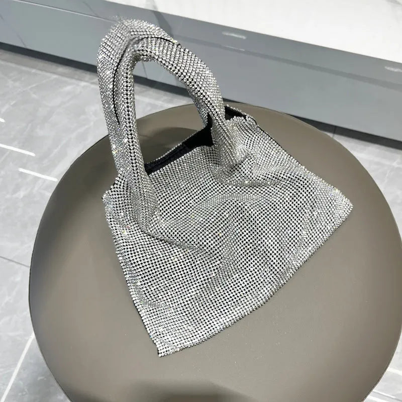 Silver evening handbag with shiny rhinestone decoration and cotton thread construction
