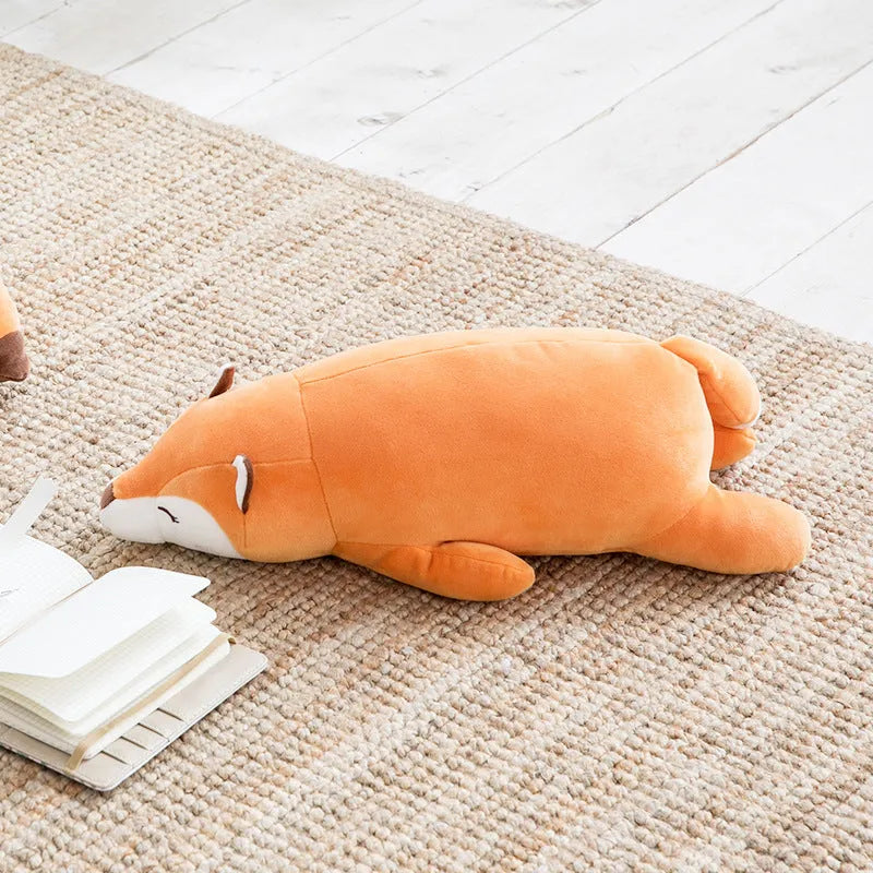 Cute fluffy fat orange fox plush toy on a white background, showing its chubby cartoon shape and soft fabric