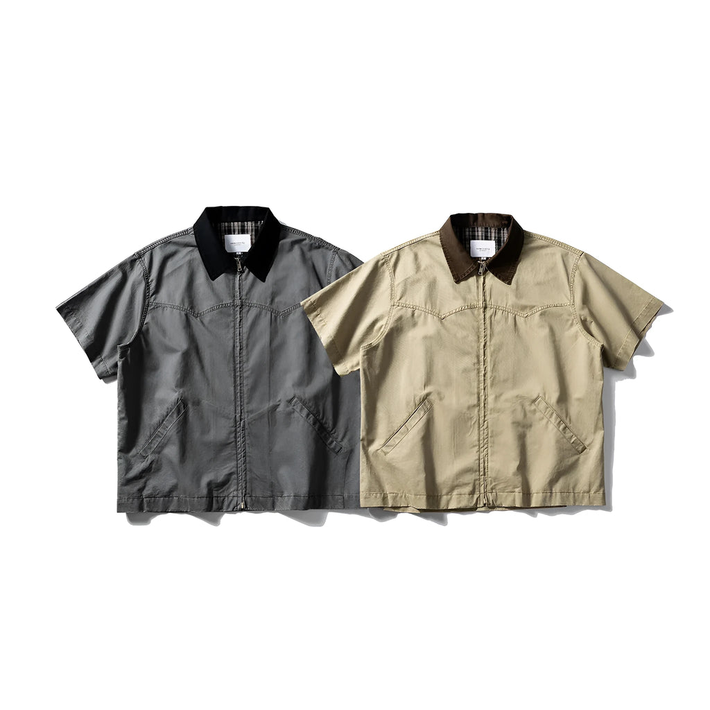A khaki washed cotton overalls shirt with short sleeves and a loose cardigan style, laid flat.
