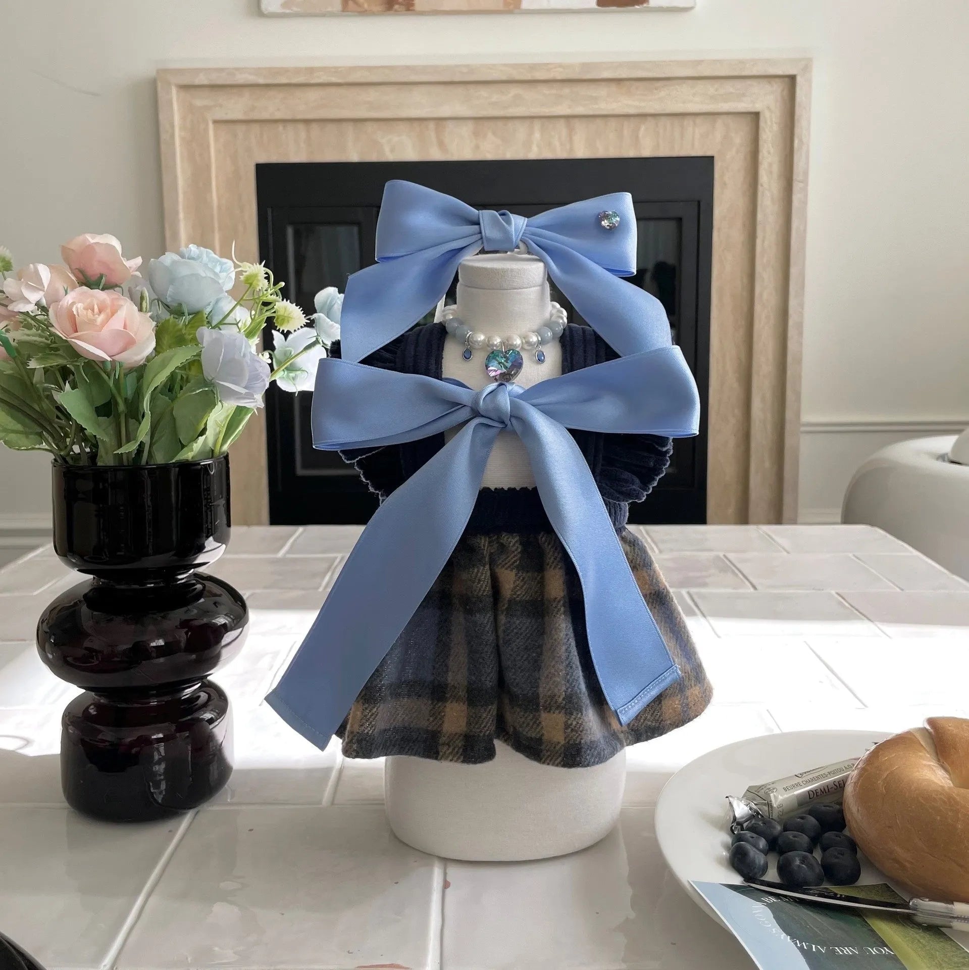 A blue dog hair band with a large princess-style bow and adjustable tension strap on a white background.