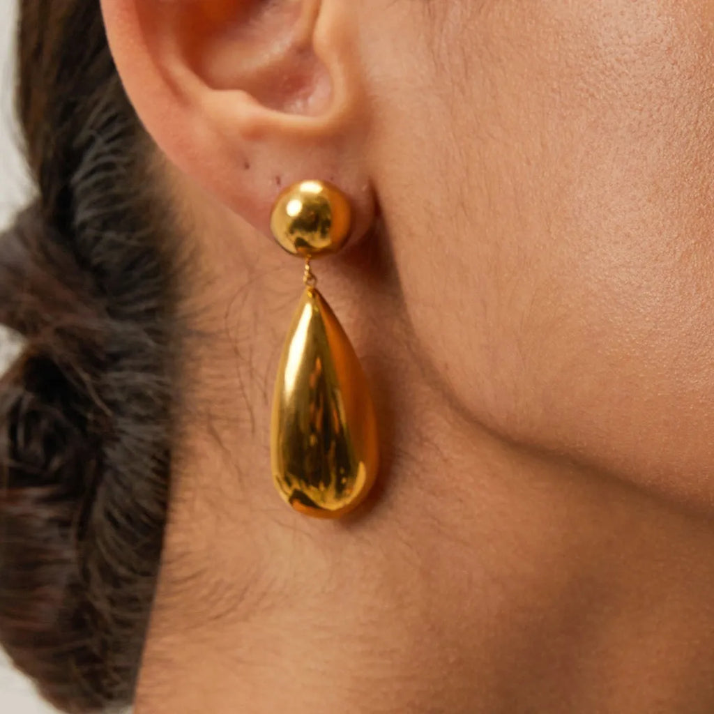 A pair of gold-coloured geometric water drop pendant earrings made from stainless steel.