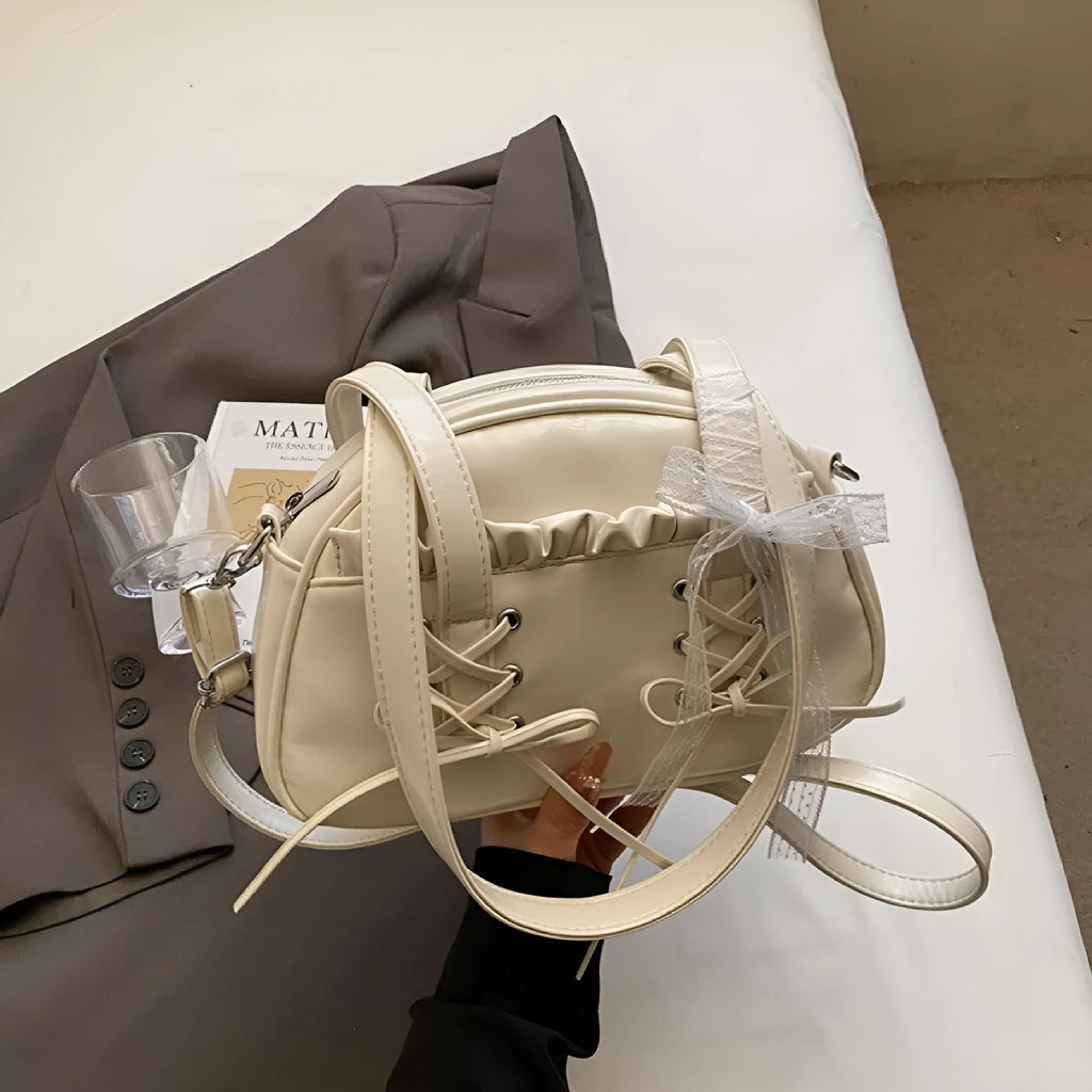 Women's casual PU shoulder handbag with bandage bow design in milky white colour showing sewing thread details
