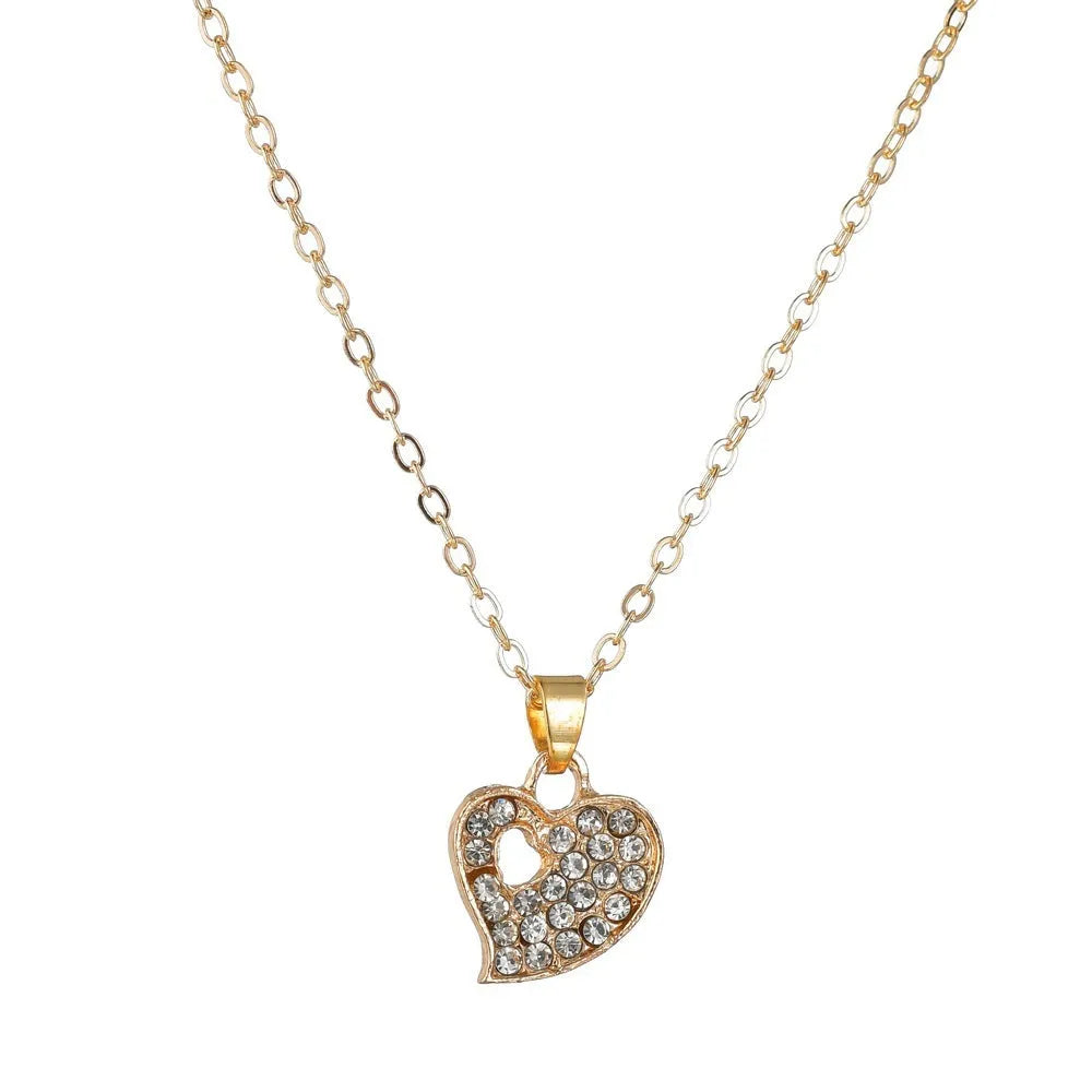 Women's gold tone alloy jewelry set with matching earrings, pendant and bracelet featuring love patterns