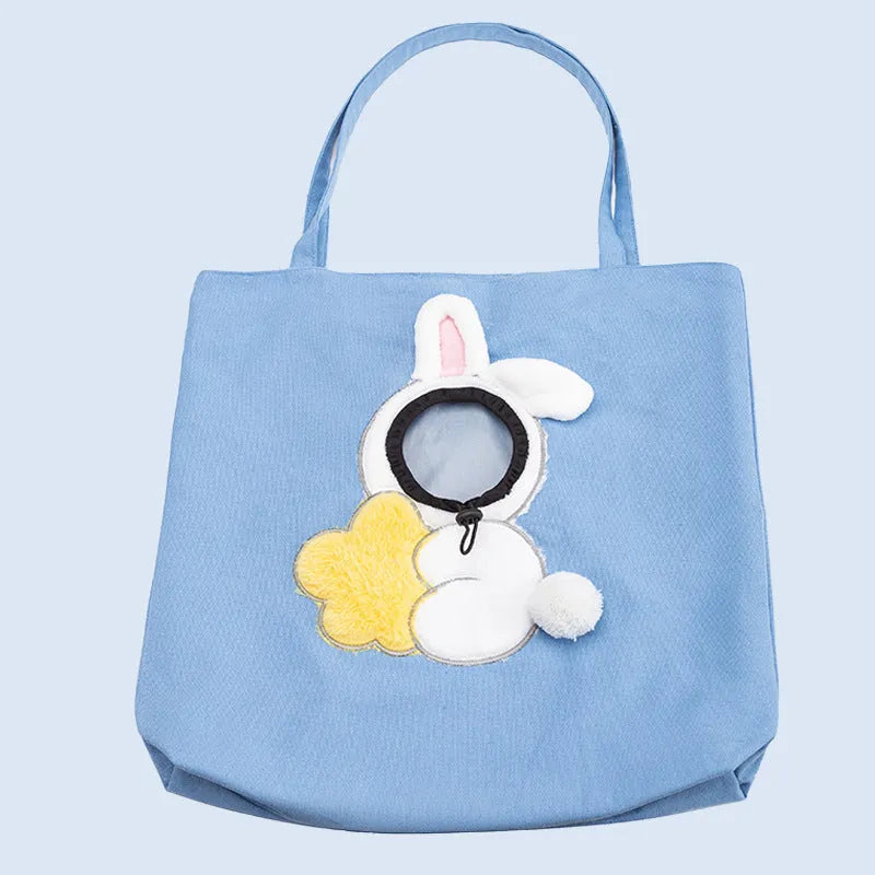 Blue canvas pet carrier shoulder bag with an open side showing a cat's head, featuring safety zippers and an animal print design.