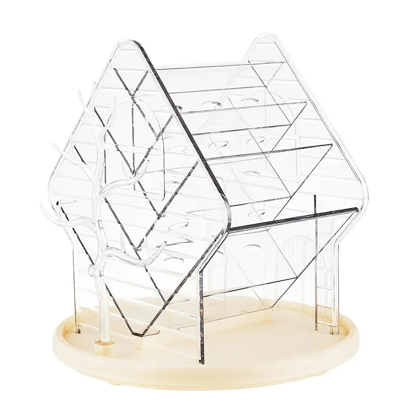 Clear plastic rotating makeup storage box organiser with 360-degree spin base on a dressing table.