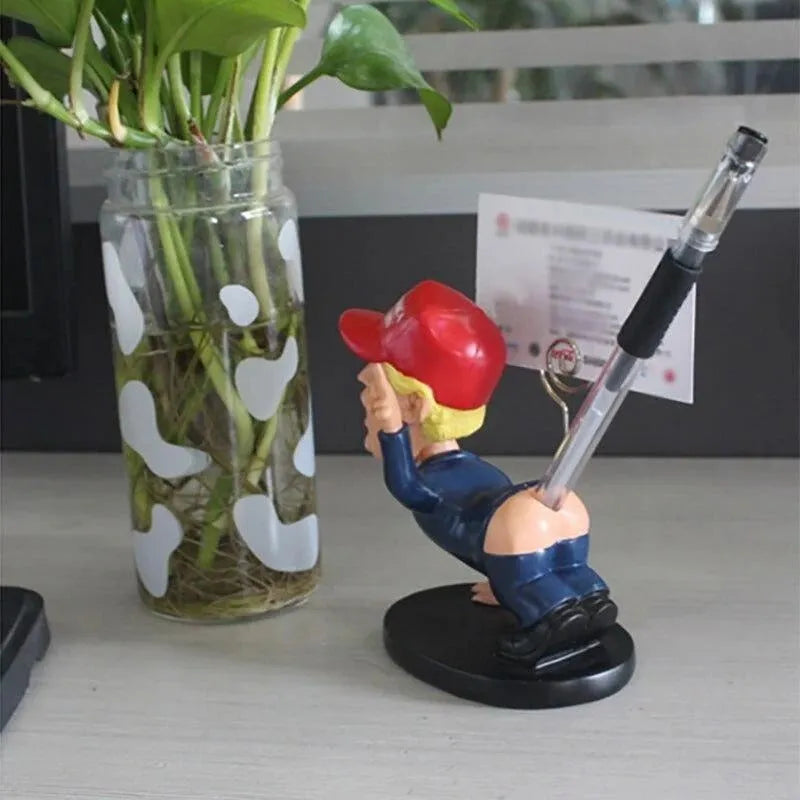 Blue synthetic resin pen holder and business card holder with shaking head doll design on a desk