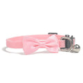 Colourful striped nylon bow collar for cats with an adjustable strap and small bell attached.