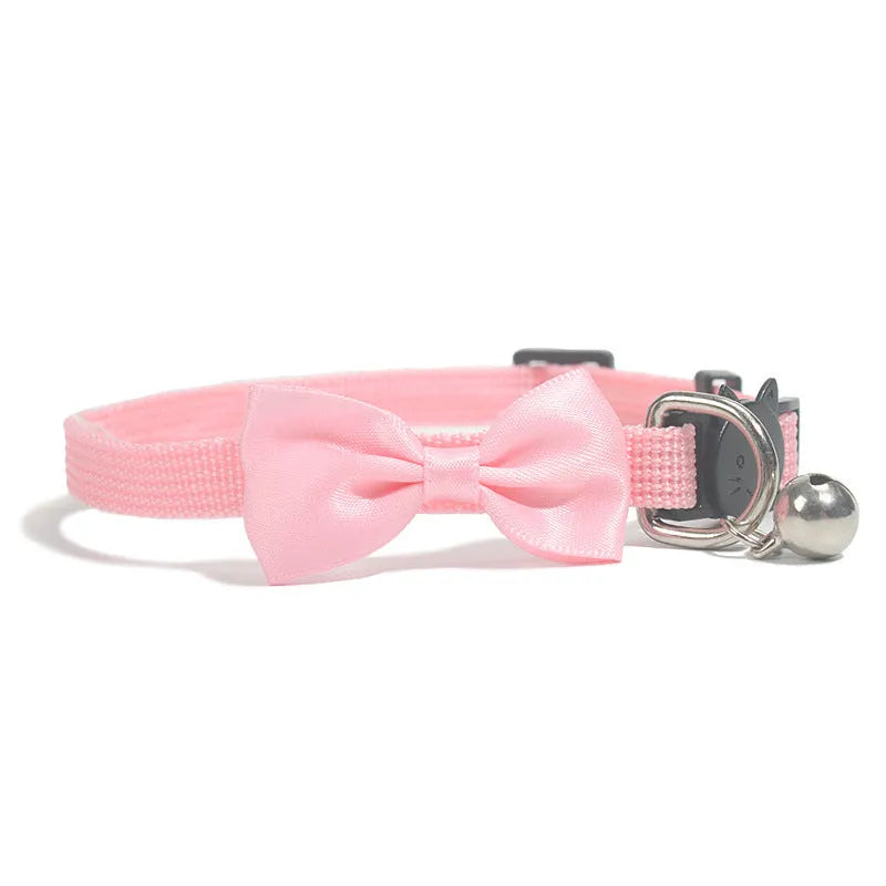 Colourful striped nylon bow collar for cats with an adjustable strap and small bell attached.