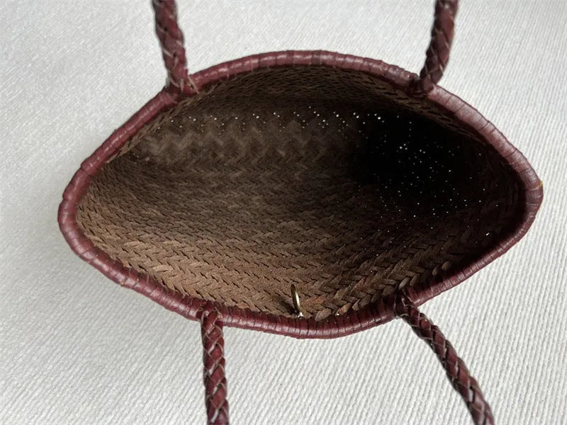 Brown vintage woven leather tote bag with a three-dimensional front pocket.