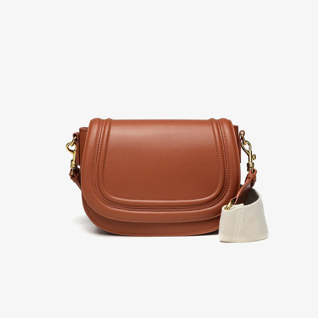 New women's crossbody bag with wide shoulder strap in PU leather, round flap shape, available in black