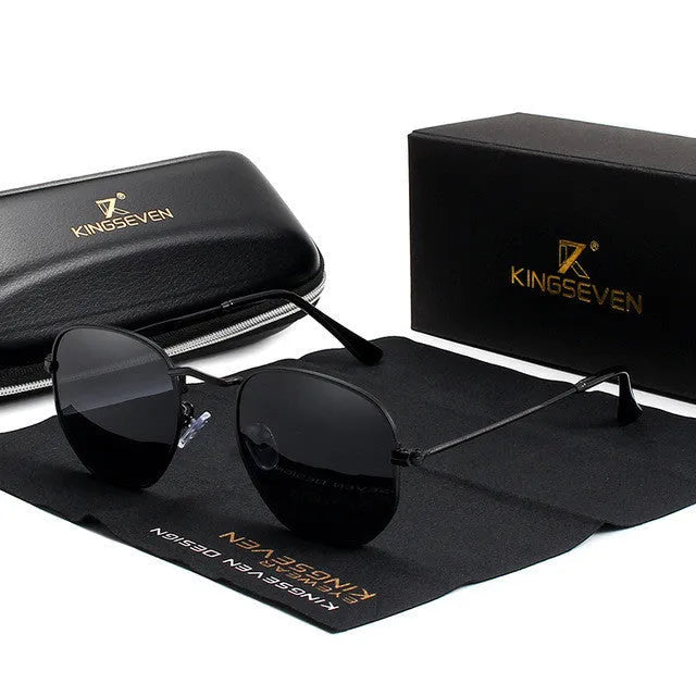 Classic round polarised sunglasses for men in gun metal grey with adjustable nose pads on a wooden table.