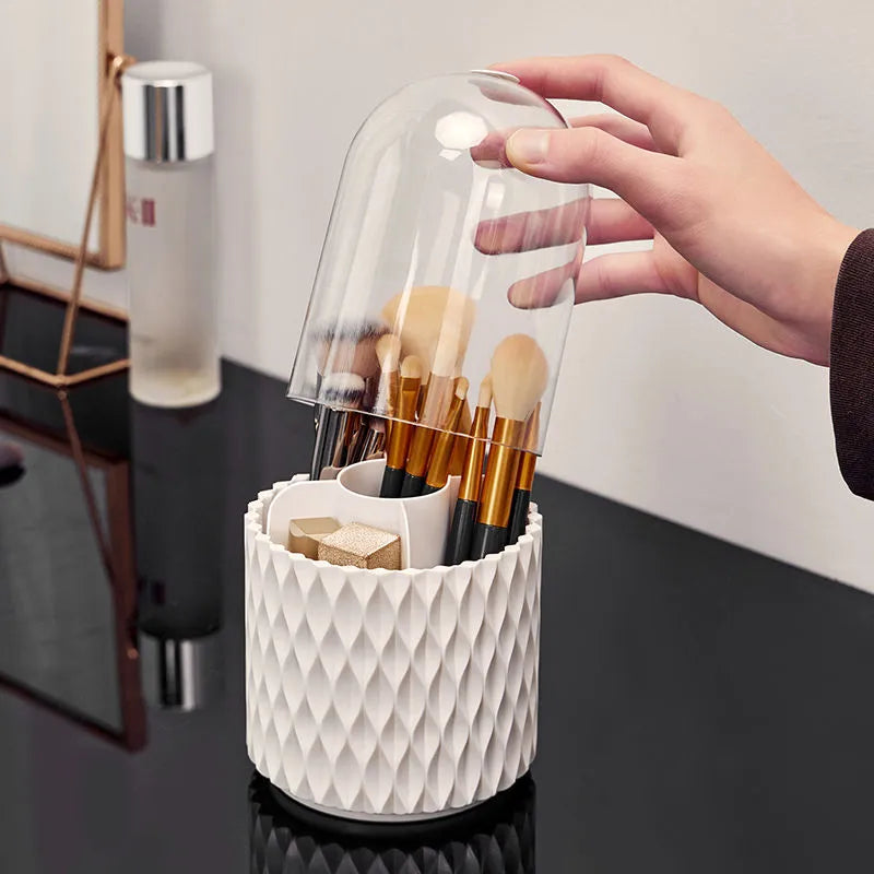 White acrylic rotating makeup brush holder with transparent dust cover showing split storage compartments
