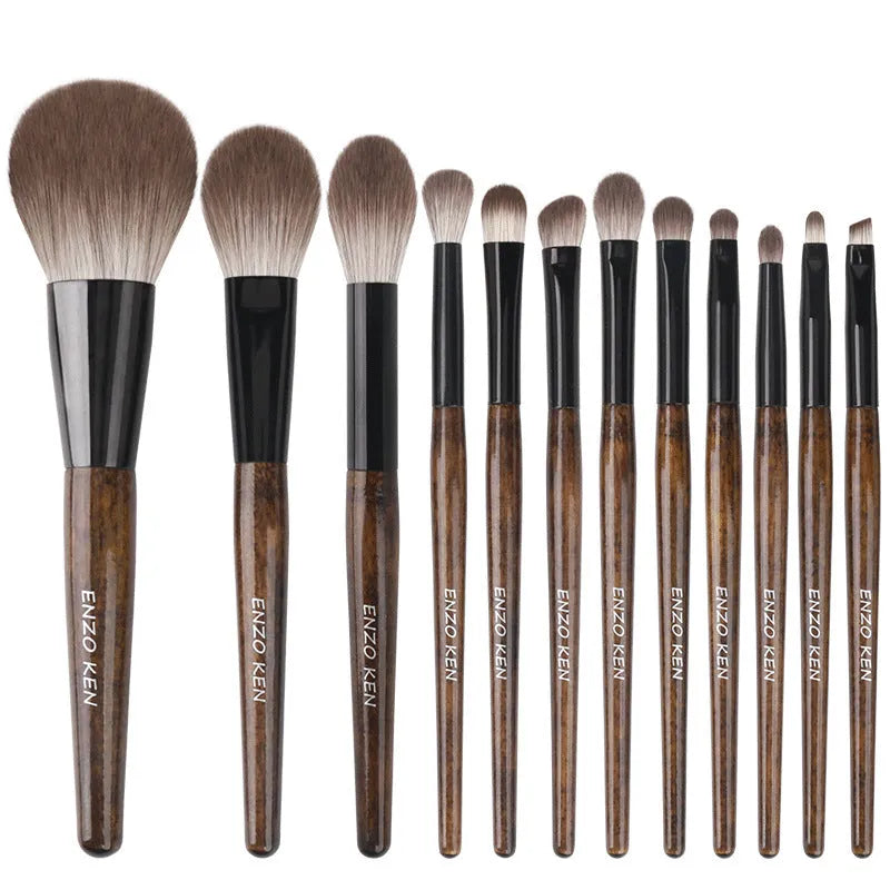 12-piece makeup brush set with wooden handles displayed in open PU brush roll