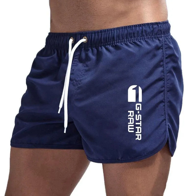 Men's thin polyester sports shorts in various colours with an elasticated waistband.