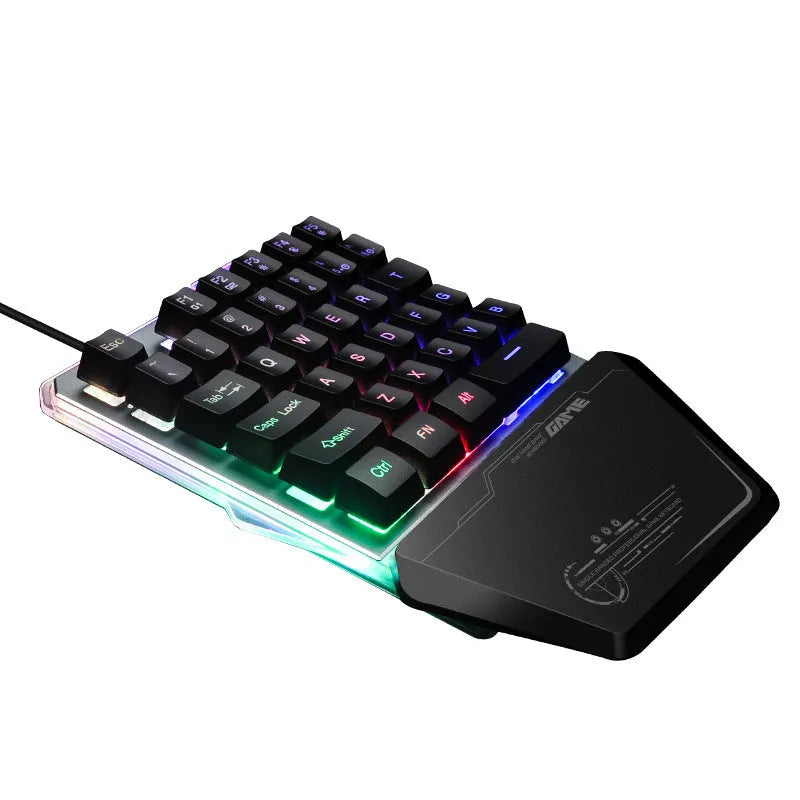 Black one-handed mechanical gaming keyboard with RGB backlit keys on a desk.