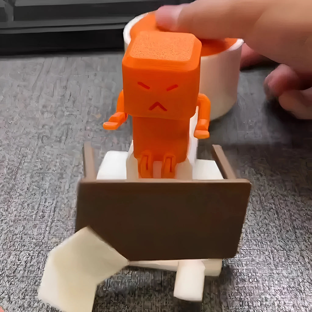 Orange plastic vent decompression toy on a table, dimensions 16cm by 6cm by 7cm.
