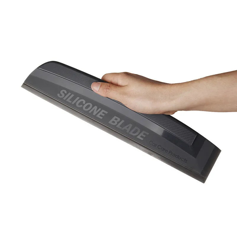 One-piece black silicone car wash wiper with flexible handle on car bonnet