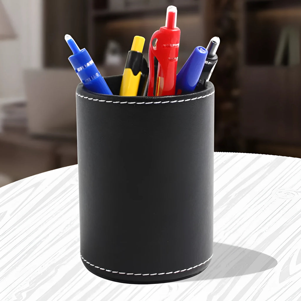 Black leather round pen holder on a desk